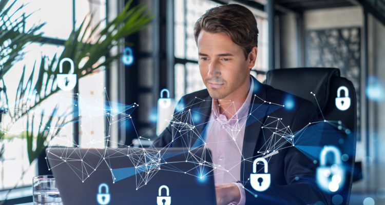 man sitting at computer that has been secured by cyber defense