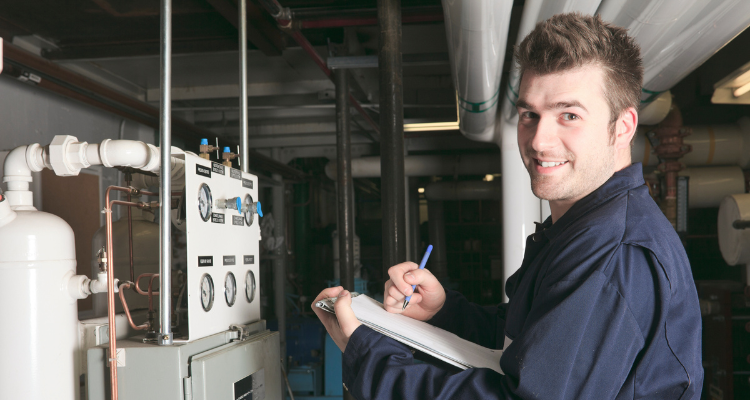 female maintenance tech working on a control panel