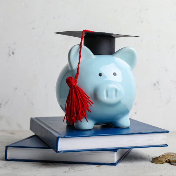 piggy bank with textbooks and hat