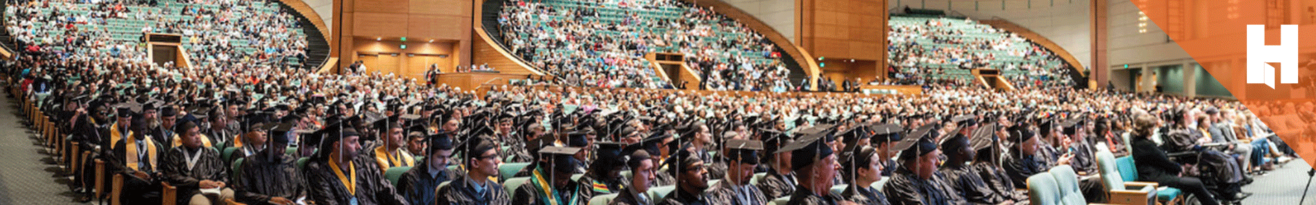 Hennepin Technical College graduation ceremony with graduates and families in an auditorium