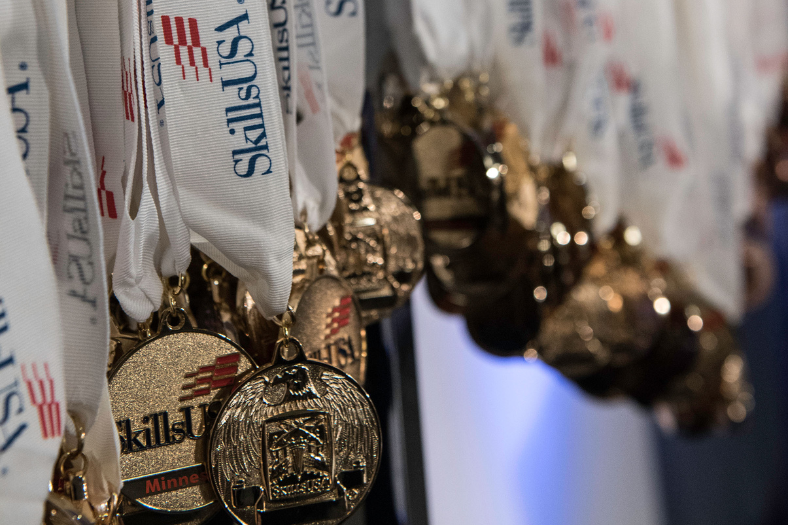 SkillsUSA medals hang in center frame.