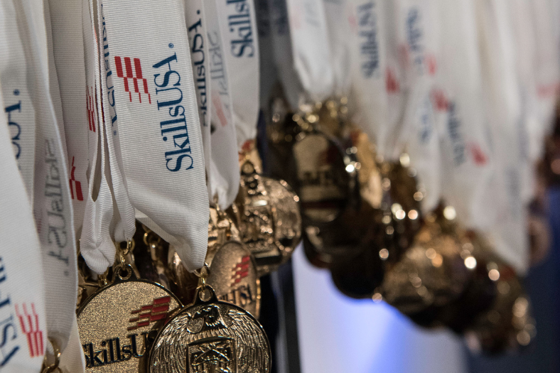 SkillsUSA competition metals viewed at an angle in moody lighting.